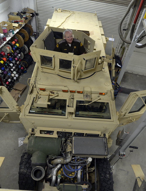Rick Egan  | The Salt Lake Tribune 

Lt. Alex Lepley stands inside a mine-resistant vehicle (MRAP)  is being fixed up for duty at the UHP maintenance shop in Taylorsville, Monday, January 13, 2014.