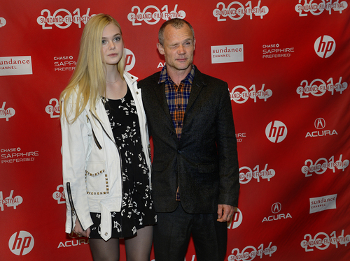 Scott Sommerdorf   |  The Salt Lake Tribune
Elle Fanning and a mischievous Flea pose for photos at the red carpet for "Low Down," directed by Jeff Preiss about the torrid, true life of jazz pianist Joe Albany, at the Eccles Theater, Sunday, January 19, 2014. The cast includes John Hawkes, Elle Fanning, Glenn Close, Peter Dinklage, Lena Headey and Flea; The film is part of the U.S. Dramatic Competition program.