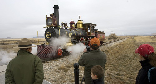 Al Hartmann  |  The Salt Lake Tribune
Fols gather for a picture of Union Pacific steam locomotive 199 as it rolls down the track to the Golden Spike National Historic Site visitor center in northwestern Utah Wednesday December 28.   Golden Spike holds its annual Winter Steam Festival on December 28-30 Folks can get up close to tour the locomotive cab, see steam demonstrations as well as take a ride on a muscle powered handcart.