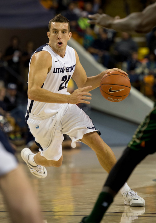 Trent Nelson  |  The Salt Lake Tribune
Utah State Aggies guard/forward Spencer Butterfield (21) dribbles the ball as Utah State University hosts Colorado State, NCAA basketball, Wednesday January 15, 2014 in Logan.