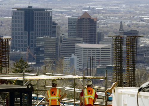 |  Tribune file photo
With a view of downtown Salt Lake City, construction workers work on building the Ambulatory Care Complex on the University of Utah's campus in Salt Lake City in 2013. New poll number indicate Utah building contractors plan to hire workers in 2014.