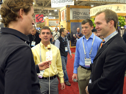 Rick Egan  | The Salt Lake Tribune 

Ryan Gellert from Black Diamond (left) checks out the Wolf em Sticks, made by Tanner  and Spencer Harrison, along with Salt Lake County Mayor Ben McAdams, at the Outdoor Retailers Convention, at the Salt Palace, Thursday, January 23, 2014.