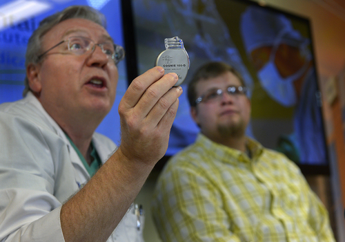Scott Sommerdorf   |  The Salt Lake Tribune
Cardiologist Jeff Osborn, M.D. holds up the device he implanted in patient Brandon England, 20, right, as he speaks about the procedure at Intermountain Medical Center Heart Institute. The institute made heart history with the implantation of Utah's first subcutaneous cardiac defibrillator to prevent sudden death from cardiac arrest, Thursday, January 23, 2014.
