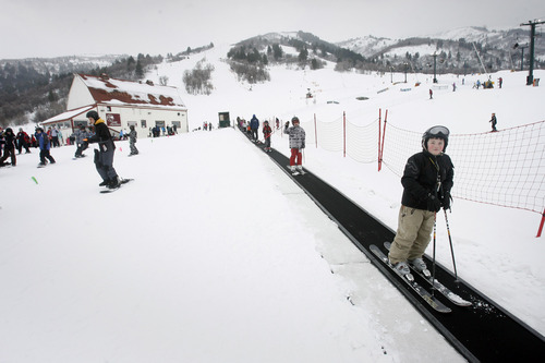 Rick Egan  |  Tribune file photo
Young skiers ride on the "magic carpet" at Wolf Creek Resort's ski area in the Ogden Valley. The resort has been sold to an investor group and will be renamed Skyline Mountain Base next winter.