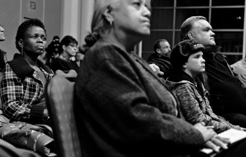 Keith Johnson | The Salt Lake Tribune

Victoria Sethunya, left, Juanita Ramos Corum, center, and West Valley City councilman Lars Nordfelt and his son Gideon listen to West Valley City police chief Lee Russo during an open meeting with the community at the Utah Cultural Celebration Center, January 23, 2014. Russo discussed crime prevention, accountability within the department and future plans for the organization. Russo plans to hold the meetings monthly.