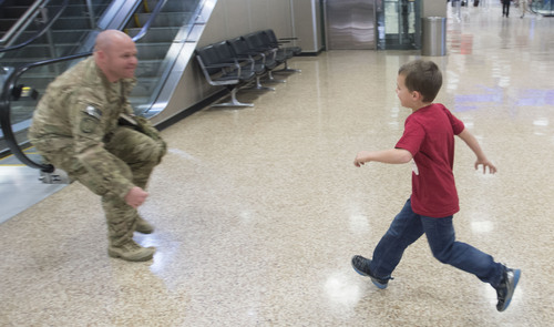 Steve Griffin  |  The Salt Lake Tribune

Jack Curzon runs to his father 1st Lt. Lance Curzon of the Utah Army National Guard's 204th Maneuver Enhancement Brigade as he returns to Utah from a 10-month deployment to Afghanistan. Lance was met by his children Jack, Camden, Ruby and his wife Amy.  The mission of the 204th was to conduct base operations and base defense for U.S. military installations in Northern Afghanistan in support of Operation Enduring Freedom. Soldiers returned home at the Salt Lake City International Airport  Friday, January 24, 2014.