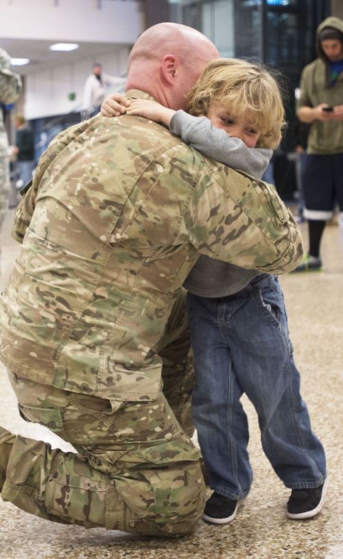 Steve Griffin  |  The Salt Lake Tribune

Camden Curzon, right,  hugs his father 1st Lt. Lance Curzon of the Utah Army National Guard's 204th Maneuver Enhancement Brigade as he returns to Utah from a 10-month deployment to Afghanistan. Lance was met by his children Jack, Camden, Ruby and his wife Amy. The mission of the 204th was to conduct base operations and base defense for U.S. military installations in Northern Afghanistan in support of Operation Enduring Freedom. Soldiers returned home at the Salt Lake City International Airport  Friday, January 24, 2014.