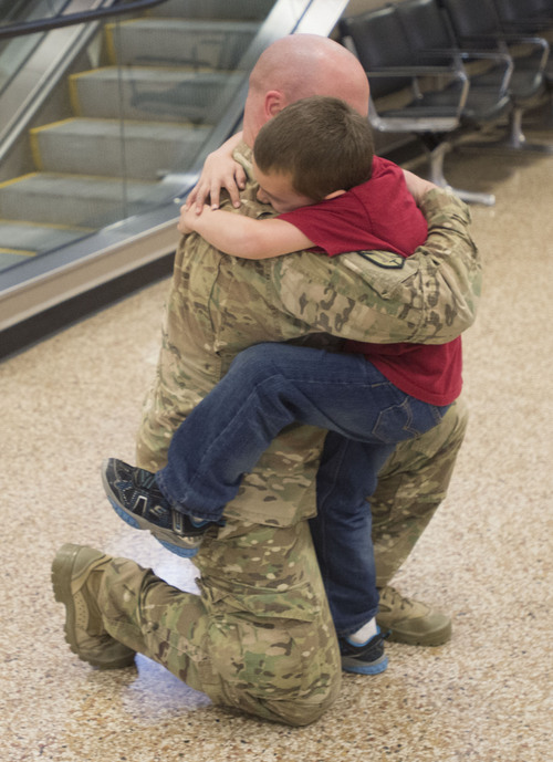 Steve Griffin  |  The Salt Lake Tribune

Jack Curzon hugs his father 1st Lt. Lance Curzon, of the Utah Army National Guard's 204th Maneuver Enhancement Brigade, as he returns to Utah from a 10-month deployment to Afghanistan. Lance was met by his children Jack, Camden, Ruby and his wife Amy. The mission of the 204th was to conduct base operations and base defense for U.S. military installations in Northern Afghanistan in support of Operation Enduring Freedom. Soldiers returned home at the Salt Lake City International Airport Friday, January 24, 2014.