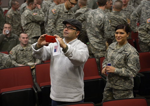 Scott Sommerdorf   |  The Salt Lake Tribune
Spc. Jose "Joe" Artalejo's father, who also goes by Joe, makes a photo of his son after the medal presentation. Artalejo, of the 118th Engineer (Sapper) Company, Utah Army National Guard, received the Purple Heart in a ceremony Saturday, Jan. 25, 2014, at Camp Williams. Artalejo, of Pleasant Grove, qualified for the Purple Heart due to wounds he received during an improvised-explosive-device incident on Dec. 24, 2010, in Khowst Province, Afghanistan.