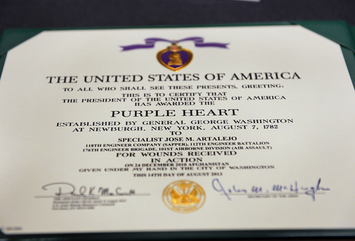Scott Sommerdorf   |  The Salt Lake Tribune
The certificate issued with Spc. Jose "Joe" Artalejo's Purple Heart. Artalejo, of the 118th Engineer (Sapper) Company, Utah Army National Guard, received the Purple Heart in a ceremony Saturday, Jan. 25, 2014, at Camp Williams. Artalejo, of Pleasant Grove, qualified for the Purple Heart due to wounds he received during an improvised-explosive-device incident on Dec. 24, 2010, in Khowst Province, Afghanistan.