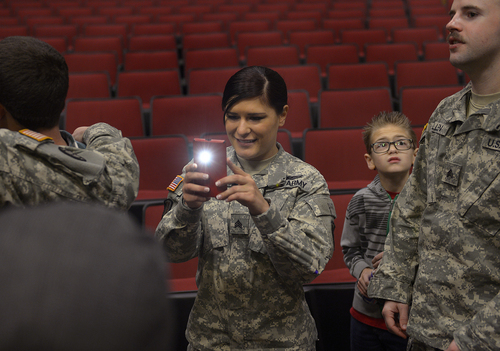 Scott Sommerdorf   |  The Salt Lake Tribune
Spc. Jose "Joe" Artalejo's sister, Sgt. Somaya Andreason, makes a photo of her brother after his medal presentation. Artalejo, of the 118th Engineer (Sapper) Company, Utah Army National Guard, received the Purple Heart in a ceremony Saturday, Jan. 25, 2014, at Camp Williams. Artalejo, of Pleasant Grove, qualified for the Purple Heart due to wounds he received during an improvised-explosive-device incident on Dec. 24, 2010, in Khowst Province, Afghanistan.