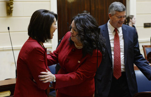 Francisco Kjolseth  |  The Salt Lake Tribune
Senators Deidre Henderson (R-Spanish Fork) and Luz Robles (D-Salt Lake) laugh as they realize they wore the exact same suit for the start of the 45-day 2014 legislative session which began on Monday, Jan. 27.