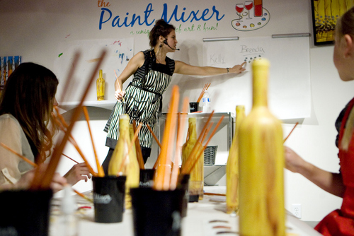 Keith Johnson |  Tribune file photo

Paint Mixer instructor Brenda Hattingh demonstrates a specific step to participants following along and painting a wine bottle at the Paint Mixer location in Salt Lake City, November 7, 2013. Paint Mixer gives participants the opportunity to enjoy a glass of wine or beer, and follow an instructor step-by-step to recreate a featured painting. Paint Mixer has two locations, Sugar House and Park City.