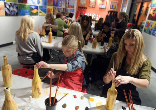 Keith Johnson |  Tribune file photo

Hillary Maxwell (right) and her daughter Makaela paint wine bottles at Paint Mixer in Salt Lake City, November 7, 2013. Paint Mixer gives participants the opportunity to enjoy a glass of wine or beer, and follow an instructor step-by-step to recreate a featured painting. Paint Mixer has two locations, Sugar House and Park City.