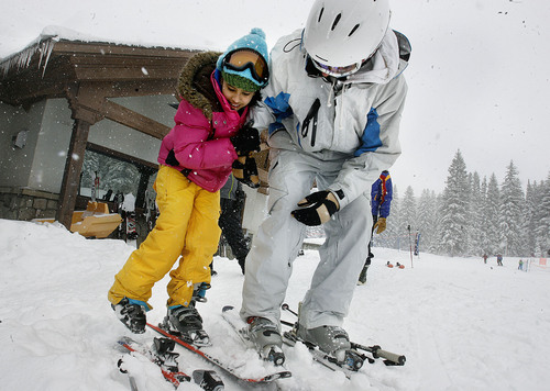 Scott Sommerdorf  |  The Salt Lake Tribune
Westminster student Joey Cathcart (right) helps Nepalese refugee Bhakti Dahal with her skis as they start out onto the slopes for her first ski lesson. With the help and support of Westminster College and Solitude Ski Resort, 15 to 20 refugee children will ski for the first time, Saturday, April 3rd, 2011.