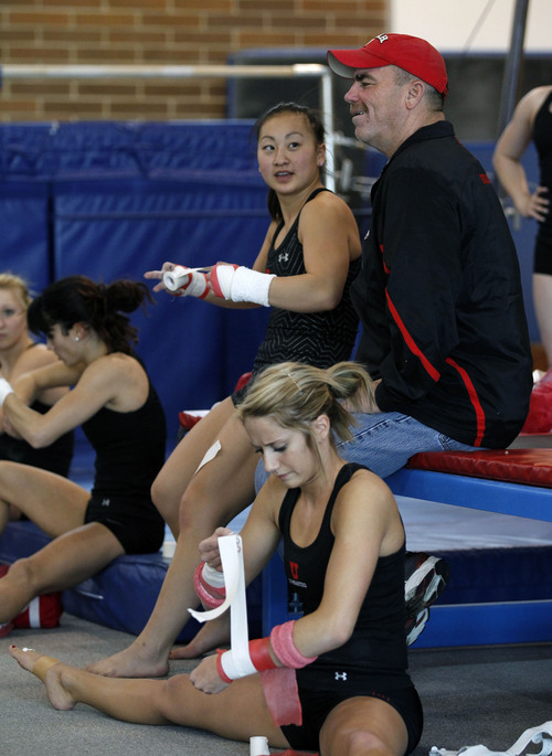 Al Hartmann  |  Tribune file photo
Ute gymnastics coach Greg Marsden talks with team members as they tape their wrists before a work out.