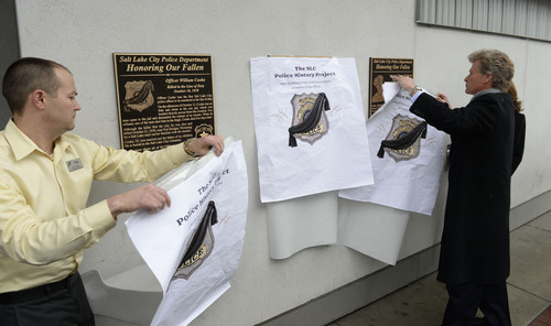 Francisco Kjolseth  |  The Salt Lake Tribune
Todd Jensen, left, store director with Harmons dowtown and Mike Farley unveil the plaques to honor three officers killed in 1858, 1894 and 1951 when the police station used to be across the street from Harmons City Creek on 100 South. The Salt Lake City Police History Project held the ceremony to recognize officers William Cooke, Sergeant Allonzo M. Wilson, and Sergeant Thomas W. Stroud.