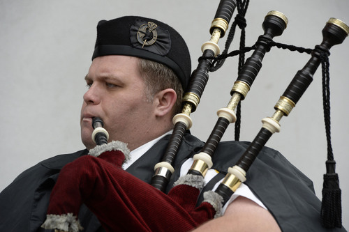 Francisco Kjolseth  |  The Salt Lake Tribune
Ian Williams with the Sandy Police Department plays the bagpipes during a ceremony to recognize three officers killed in the line of duty. Harmons City Creek agreed to host the bronze plaques on the 100 South entrance to its downtown store, across the street from which the three were killed in separate events in 1858, 1894 and 1951.