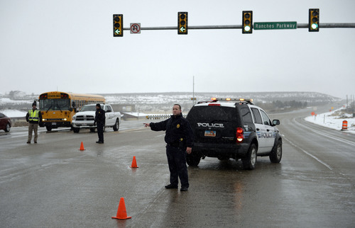 Francisco Kjolseth  |  The Salt Lake Tribune
Police direct traffic off of State Road 73 at Ranches Parkway near Eagle Mountain on Thursday, Jan. 30, 2014, after an officer shooting incident farther down the road.