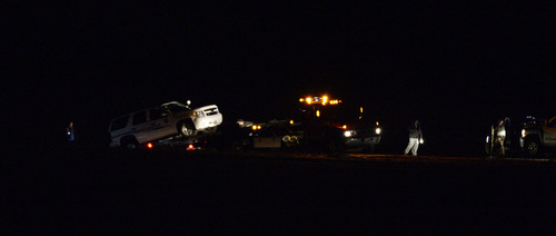 Francisco Kjolseth  |  The Salt Lake Tribune
The patrol car belonging to Utah County Sheriff's Sgt. Cory Wride who was ambushed in his car along SR 73 near Eagle Mountain is loaded onto a flat bed truck late on Thursday, Jan. 30, 2014.
