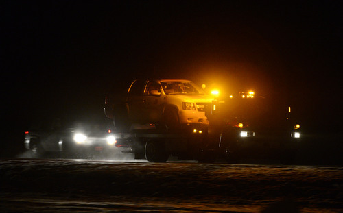Francisco Kjolseth  |  The Salt Lake Tribune
The patrol car belonging to Utah County Sheriff's Sgt. Cory Wride who was ambushed in his car along SR 73 near Eagle Mountain is loaded onto a flat bed truck late on Thursday, Jan. 30, 2014.