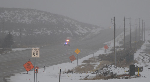 Francisco Kjolseth  |  The Salt Lake Tribune
Police head down SR 73 as they leave the scene of an officer shooting further up the road near Eagle Mountain on Thursday, Jan. 30, 2014.