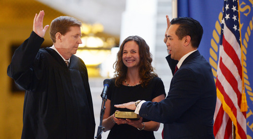 Steve Griffin  |  The Salt Lake Tribune

Saysha Reyes holds the Bible as her husband, Sean Reyes, is sworn in as attorney general by Utah Supreme Court Chief Justice Matthew B. Durrant at the Utah State Capitol Rotunda in Salt Lake City Monday, Dec. 30, 2013.
