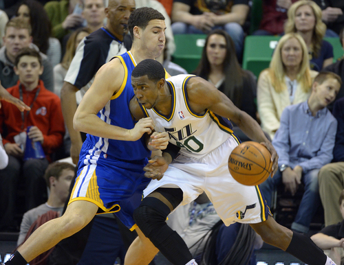 Scott Sommerdorf   |  The Salt Lake Tribune
Jeremy Evans drives on Golden State's Klay Thompson during first period play as the Jazz hosted the Golden State Warriors, Friday, Jan. 31, 2014.