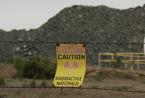 Tribune file photo

A caution sign on a fence in front of ore from the Pandora Mine outside La Sal that is piled before processing at the White Mesa Mill outside Blanding, Utah, in this May 23, 2007, file photo.
