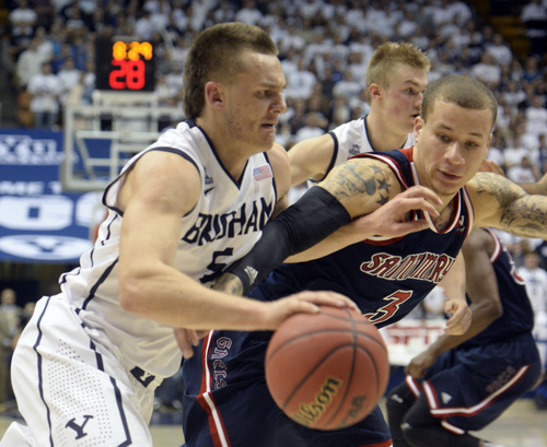 Rick Egan  | The Salt Lake Tribune 

Brigham Young Cougars guard Kyle Collinsworth (5) drives to the basket, as St. Mary's Gaels guard Kerry Carter (3) defends, in basketball action, BYU vs. St Mary's, at the Marriott Center, Saturday, February 1, 2014.