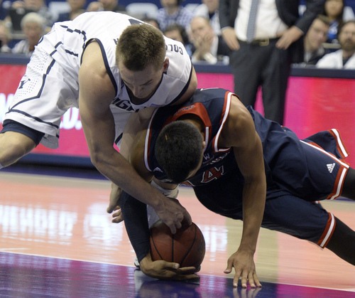 Rick Egan  | The Salt Lake Tribune 

Brigham Young Cougars guard Kyle Collinsworth (5) goes for a loose ball along with St. Mary's Gaels guard Stephen Holt (14) in basketball action, BYU vs. St Mary's, at the Marriott Center, Saturday, February 1, 2014.