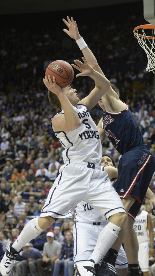 Rick Egan  | The Salt Lake Tribune 

Brigham Young Cougars guard Kyle Collinsworth (5) shoots as St. Mary's Gaels forward Dane Pineau (11) in basketball action, BYU vs. St Mary's, at the Marriott Center, Saturday, February 1, 2014.