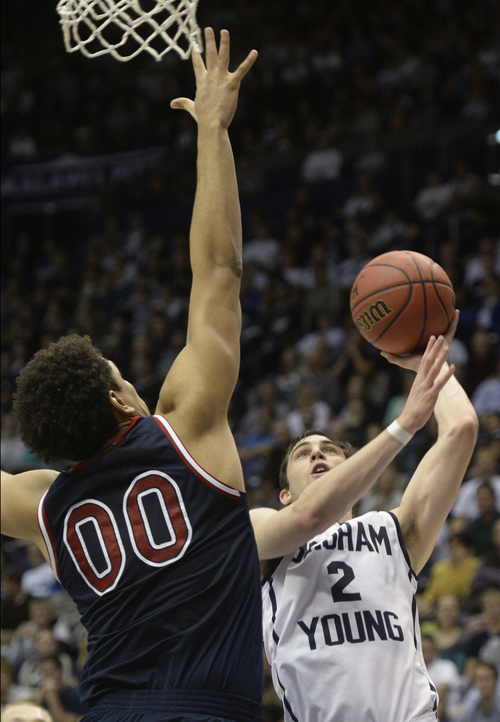 Rick Egan  | The Salt Lake Tribune 

St. Mary's Gaels Brad Waldow (00), defends, as Brigham Young Cougars guard Matt Carlino (2) takes a shot, in basketball action, BYU vs. St Mary's, at the Marriott Center, Saturday, February 1, 2014.