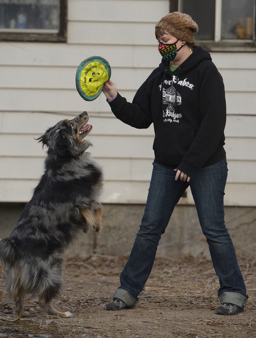 Leah Hogsten  |  The Salt Lake Tribune
 Meghan Smith, playing fetch with her dog Saddie at her home, has begun wearing an air mask on when air quality along the Wasatch Front reaches "unhealthy" levels, which exacerbates her asthma.
