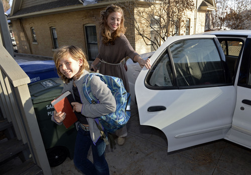Francisco Kjolseth  |  The Salt Lake Tribune
Tiffany Lundeen and her children Heron Lundeen, 8, pictured, and Azure Frost, 5, unload from their compressed natural gas fueled car after school on Thursday, Jan. 23, 2014. Tiffany and her husband Adam Frost moved to Utah four years ago and are already looking to leave because of the bad air. They were aware Utah had a bad air quality problem and even replaced their two gas-burning cars with CNG vehicles before locating here as their own personal contribution to helping reduce pollution.