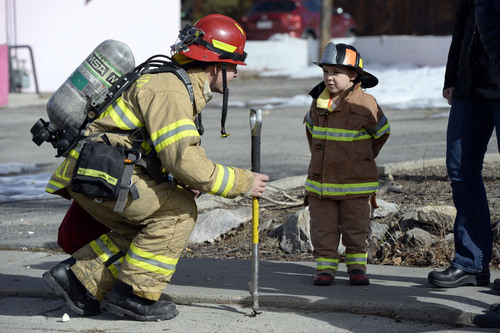 Francisco Kjolseth  |  The Salt Lake Tribune
Max Stevens, 3, who always wears his firefighter suit according to his parents gets a rare opportunity to see his idols in action near his home as he meets Captain Steve Crandall of Station 5. Crandall and other firefighters were called to Chabad Community Center at 1760 South 1100 East in Salt Lake City on Monday, Feb. 3, 2014, when smoke was reported.