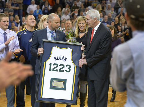 Scott Sommerdorf   |  The Salt Lake Tribune
Steve Miller hands Jerry Sloan a commemorative jersey with noting his total NBA victories as he was honored during halftime as the Jazz hosted the Golden State Warriors, Friday, Jan. 31, 2014.