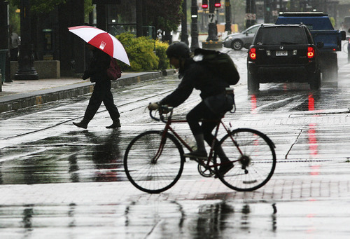 Steve Griffin | The Salt Lake Tribune


A biker gets caught in an afternoon rain shower as it whips through downtown Salt Lake City, Utah Tuesday May 28, 2013.