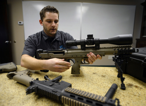 Steve Griffin  |  The Salt Lake Tribune

Seth Ercanbrack, marketing manager for Desert Tech in West Valley City, Utah, with a SRS Covert sniper rifle at the company's offices Friday, January 31, 2014. Desert Tech is a Utah gun manufacturer developing one of the more accurate military rifles on the market.