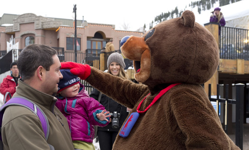 Trent Nelson  |  The Salt Lake Tribune
Two-year old Lily Weinberg gets some affection from Olympic mascot Coal, as celebrations for the 10-year anniversary of the 2002 Winter Olympics kicked off Wednesday, Feb. 1, 2012 in Park City. Weinberg's father Jon at left. Anniversary festivities continue Friday and Saturday at the Kearns Olympic Oval, The Gateway mall and EnergySolutions Arena.