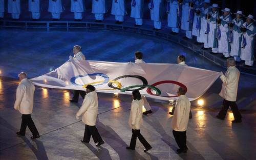 Francisco Kjolseth |   Tribune file photo

The Olympic flag is brought in during opening ceremonies for the 2002 Winter Games at Rice-Eccles Stadium.