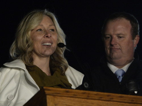 Rick Egan  | The Salt Lake Tribune 

Nanette Wride, wife of Cory Wride,  speaks at the candlelight vigil in honor of Sgt. Cory Wride and injured Deputy Greg Sherwood, in Spanish Fork, Sunday, February 2, 2014.  Johnny Revill , family spokesman is on the right.