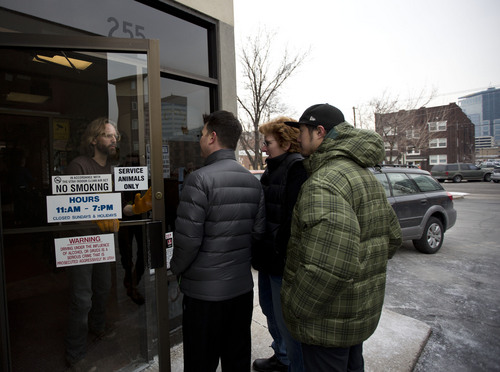 Lennie Mahler  |  The Salt Lake Tribune
A DABC employee opens the door of the downtown Salt Lake City state wine store to the first three customers in line, who waited early for bottles of rare whiskey from the Old Rip Van Winkle Distillery. Thursday, Feb. 6, 2014.