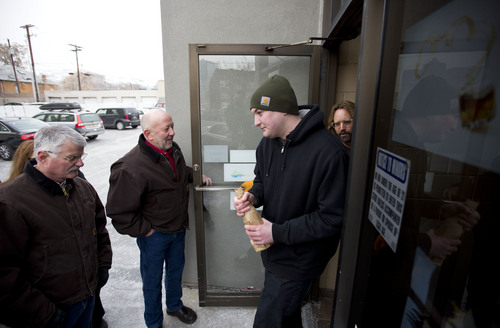 Lennie Mahler  |  The Salt Lake Tribune
Ryan Taylor leaves the state wine store in downtown Salt Lake City with a bottle of whiskey from the Old Rip Van Winkle Distillery, Thursday, Feb. 6, 2014.