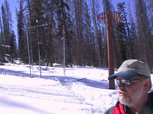 | Courtesy
Randy Julander, snow survey specialist with the Natural Resources Conservation Service, which is a division of the U.S. Department of Agriculture, visited the SNOTEL measuring station Wednesda(02/22/) on Cedar Mountain, 17 miles east of Cedar City. The snow pack this year measures 40 inches at the site compared with 165 inches measured at the site in 2005. The orange flag on the metal pole indicates surface of snow pack last year. The brown tower behind Julander is a rain measuring gauge that last year required a 4-foot extension to reach the snowpack surface.