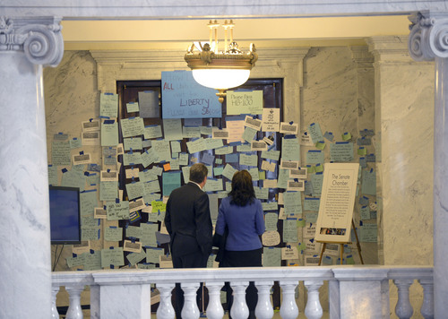 Al Hartmann  |  The Salt Lake Tribune 
People stop by the entrance doors to the Senate at the Utah State Capitol Monday morning February 3, 2014, to see it plastered with hundreds of messages to pass SB100. SB100 is sponsored by Sen. Stephen Urquhart, R-St. George. The bill modifies the Utah Antidiscrimination Act and Utah Fair Housing Act to address discrimination on the basis of sexual orientation and gender identiity.