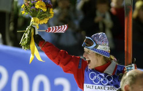 Paul Fraughton  |  Tribune file photo

USA's Shannon Bahrke  holds her flowers and her flag high, as she celebrates her silver finish in the women's moguls competition at Deer Valley.