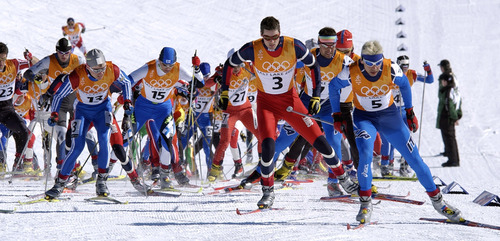 Al Hartmann  |  Tribune file photo 

Skiers try to break away from the pack following a mass start in the Men's 30K freestyle cross country skiing event at Soldier Hollow in Midway, Utah.  It was the first cross-country skiing mass start in the modern Olympic era.