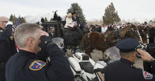 Steve Griffin  |  The Salt Lake Tribune


A horse drawn hearse delivers the body of slain Utah County Sheriff's Sgt. Cory Wride during interment services at the Spanish Fork Cemetery, in Spanish Fork, Utah Wednesday, February 5, 2014. Wride's wife, Nanette Wride, center, road with the hearse.