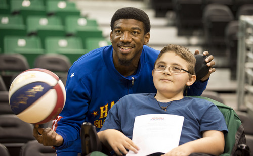 Lennie Mahler  |  The Salt Lake Tribune
Austin Bennett, a 12-year-old with Duchenne muscular dystrophy, poses with Harlem Globetrotters player Buckets Blakes on Friday, Feb. 7, 2014, at EnergySolutions Arena. Bennett will meet and watch the Harlem Globetrotters play the World All-Stars on Monday, Feb. 10, as a "bucket list" item fulfilled by the Children and the Earth charity.